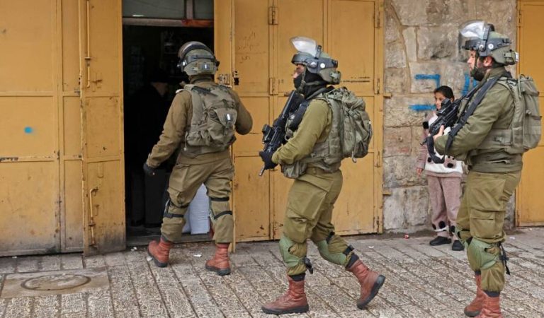 Israeli troops order Palestinian merchants to close their shops in the occupied West Bank town of Hebron on January 29, 2022, days after stones were hurled at the Jewish settlement of Beit Romano. (Photo by HAZEM BADER / AFP) (Photo by HAZEM BADER/AFP via Getty Images)