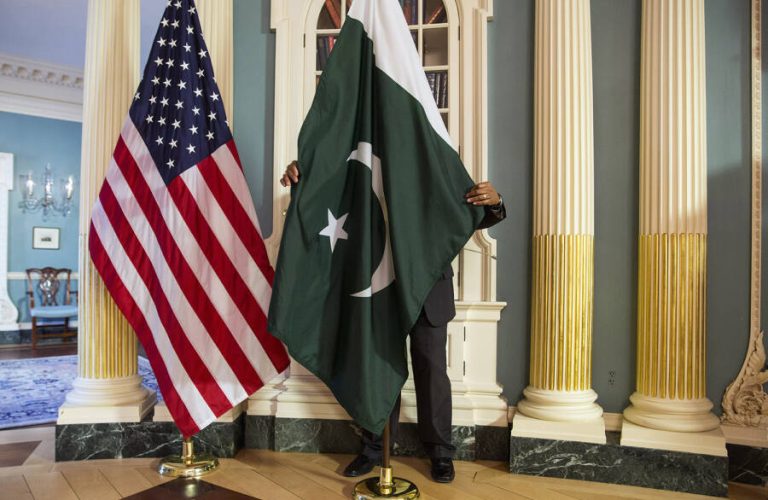 A State Department contractor adjust a Pakistan national flag before a meeting between U.S. Secretary of State John Kerry and Pakistan's Interior Minister Chaudhry Nisar Ali Khan on the sidelines of the White House Summit on Countering Violent Extremism at the State Department in Washington February 19, 2015.      REUTERS/Joshua Roberts    (UNITED STATES - Tags: POLITICS)
