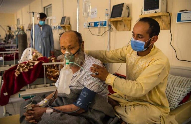 A Covid-19 patient has his back rubbed by his son inside the Intensive Care Unit at the Afghan Japan Communicable Diseases Hospital, Kabul's primary facility for the treatment of Covid-19. At the time this photo was taken, an official count of 1,200 deaths had been recorded by the Ministry of Public Health, though that figure is assumed to be far lower that the reality. The ministry released the findings of a survey the same week which indicated more than one third of Afghans had likely been infected with the disease and more than 50 percent of Kabul residents.