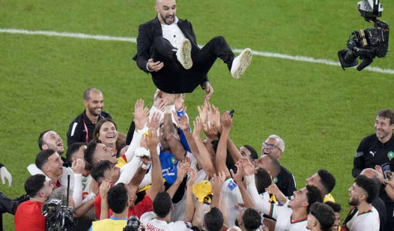 Morocco players celebrate by tossing the head coach Walid Regragui into the air at the end of the World Cup group F soccer match between Canada and Morocco at the Al Thumama Stadium in Doha , Qatar, Thursday, Dec. 1, 2022. (AP Photo/Alessandra Tarantino)