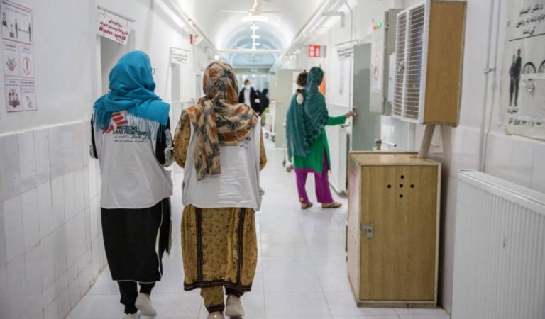 MSF staff walk down the corridor in the female inpatient department at the MSF-supported Boost hospital.