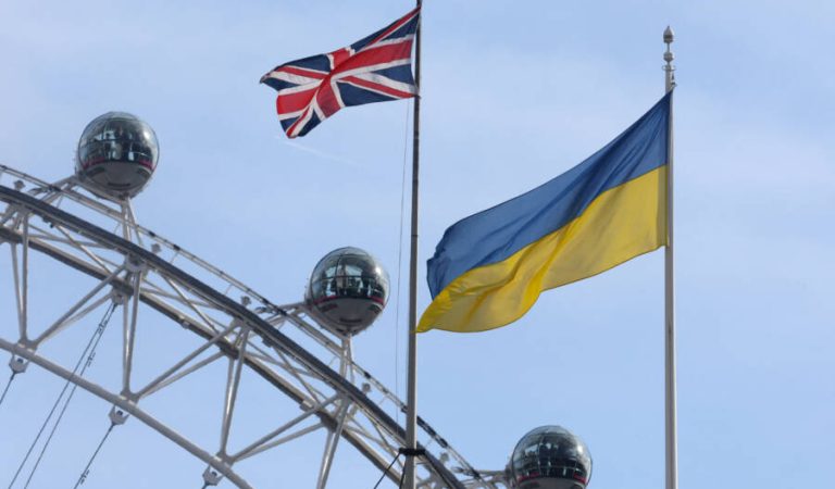 FILE PHOTO: Ukraine flag and British Union flag fly from British government buildings as people ride on the London Eye wheel attraction, in London, Britain, February 23, 2024. REUTERS/Toby Melville/ File Photo