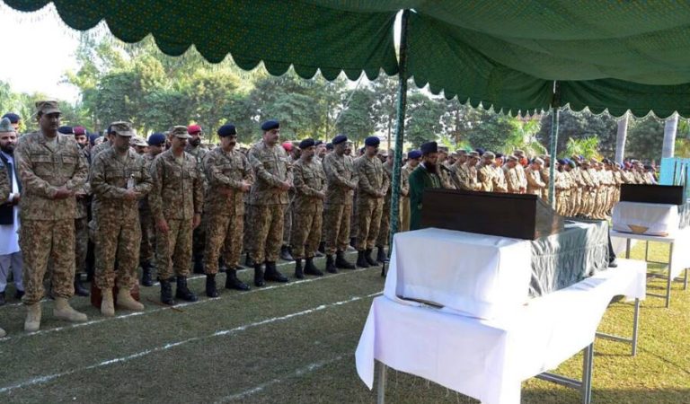 In this handout photograph released by Pakistan's Inter Services Public Relations (ISPR) on November 14, 2016, Pakistani army chief Raheel Sharif (4L) and military officials offer funeral prayers for soldiers who were killed in cross-border firing at the Line of Control (LoC) in Bhimber sector, in Jhelum some 120 kms south of Islamabad. 

The Pakistani military accused India on November 14 of killing seven soldiers in cross-border fire in disputed Kashmir, in what appeared to be an unusually high toll after months of surging tensions between the nuclear-armed neighbours. / AFP PHOTO / ISPR / HO