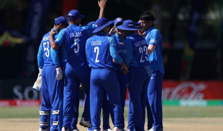 WINDHOEK, NAMIBIA - JANUARY 21: Nooristani of Afghanistan celebrates with teammates after taking the wicket of Darpan Jobanputra of Tanzania during the ICC U19 Men's Cricket World Cup 2026 match between Afghanistan and Tanzania at HP Oval on January 21, 2026 in Windhoek, Namibia. (Photo by Matthew Lewis-ICC/ICC via Getty Images)
