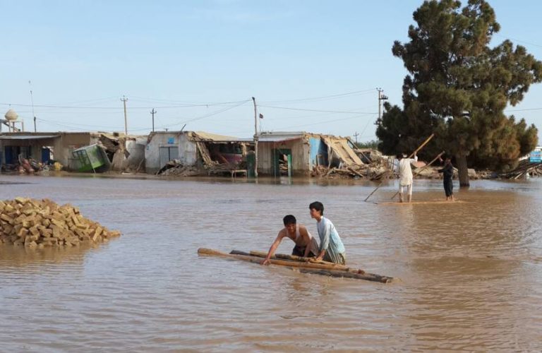 In this picture taken on Saturday, April 26, 2014, Afghan youth save their belongings from the water after a flood at Jawzjan province northern Afghanistan. An official says flooding in northern Afghanistan has killed more than 100 people and driven hundreds more from their homes. The Afghan National Army was using helicopters to rescue people trapped by the waters and ferry food and water to remote areas. (AP Photo)