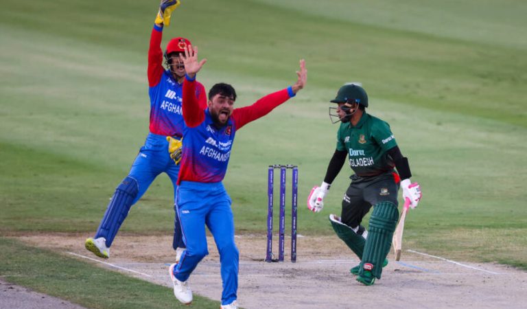 Afghanistan's Rashid Khan (C) successfully appeals for a LBW dismissal against Bangladesh's Mushfiqur Rahim (R) during the Asia Cup Twenty20 international cricket Group B match between Afghanistan and Bangladesh at the Sharjah Cricket Stadium in Sharjah on August 30, 2022. (Photo by Karim SAHIB / AFP) (Photo by KARIM SAHIB/AFP via Getty Images)