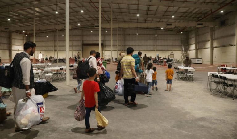 CAMP AS SAYLIYAH, QATAR - AUGUST 20:  In this handout image Afghan Special Immigrants walk through the in-processing building, August 20, 2021 at Camp As Sayliyah, Qatar. Soldiers help process Special Immigration Applicants seeking relocation to the United States.  (Photo by Sgt. Jimmie Baker / U.S. Army via Getty Images)