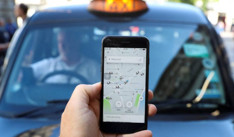 FILE PHOTO: A photo illustration shows the Uber app and a black cab in London, Britain June 26, 2018. REUTERS/Simon Dawson/Illustration/File Photo