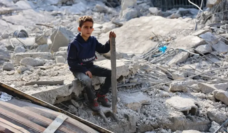 a-palestinian-boy-sits-amid-the-ruins-of-a-home-bombed-by-israeli-forces-in-jabalia-gaza