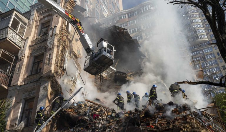 Firefighters work after a drone fired on buildings in Kyiv, Ukraine, Monday, Oct. 17, 2022. Waves of explosive-laden suicide drones struck Ukraine's capital as families were preparing to start their week early Monday, the blasts echoing across Kyiv, setting buildings ablaze and sending people scurrying to shelters. (AP Photo/Roman Hrytsyna)