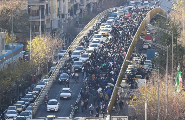 FILE - Protesters march on a bridge in Tehran, Iran, on Dec. 29, 2025. (Fars News Agency via AP, File)