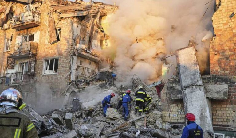 Firefighters work on the site of a burning building after a Russian attack in Kyiv, Ukraine, early Thursday, Aug. 28, 2025. (AP Photo/Efrem Lukatsky)