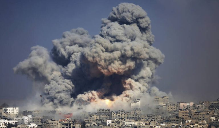 FILE - In this July 29, 2014 file photo, smoke and fire from an Israeli strike rise over Gaza City. Israel launches a pre-emptive assault on an upcoming U.N. report into last year's war in the Gaza Strip, saying it is hopelessly biased and issuing its own report that places the blame for heavy civilian casualties on Gaza’s Hamas militant rulers. The diplomatic offensive sets the stage for what is expected to be a contentious showdown with U.N. officials over allegations that Israel committed war crimes during the 50-day war. (AP Photo/Hatem Moussa, File)