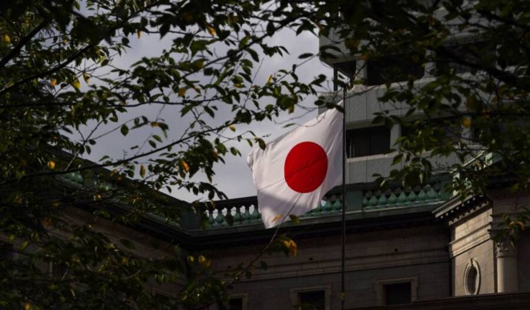 A Japanese national flag flies outside the Bank of Japan (BOJ) headquarters in Tokyo, Japan, on Sept. 27, 2021. The Bank of Japan will release its quarterly Tankan business sentiment survey on Oct. 1.