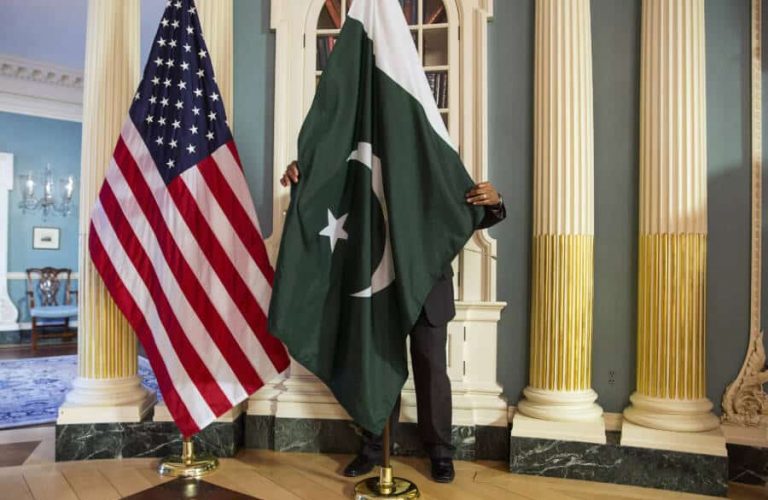 A State Department contractor adjust a Pakistan national flag before a meeting between U.S. Secretary of State John Kerry and Pakistan's Interior Minister Chaudhry Nisar Ali Khan on the sidelines of the White House Summit on Countering Violent Extremism at the State Department in Washington February 19, 2015.      REUTERS/Joshua Roberts    (UNITED STATES - Tags: POLITICS) - GM1EB2K0EFQ01
