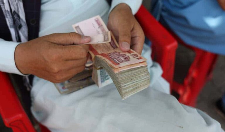 FILE PHOTO: An Afghan man counts his money after the Afghan currency faced devaluation in Kabul, Afghanistan, September 4, 2021. WANA (West Asia News Agency) via REUTERS