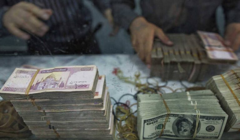 Workers count banknotes of various currencies at the headquarters of the Da Afghanistan Bank, Afghanistan's central bank, in Kabul, Afghanistan, on Tuesday, Aug. 6, 2013. A smooth U.S. exit from Afghanistan will depend on Pakistans cooperation with the logistical pullout, as well as its backing for peace talks in neighboring Afghanistan and an end to any support for extremist proxies operating there. Photographer: Victor J. Blue/Bloomberg via Getty Images