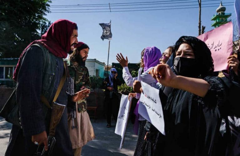 KABUL, AFGHANISTAN -- SEPTEMBER 8, 2021: Taliban fighters try to stop the advance of protesters marching through the Dashti-E-Barchi neighborhood, a day after the Taliban announced their new all-male interim government with a no representation for women and ethnic minority groups, in Kabul, Afghanistan, Wednesday, Sept. 8, 2021. (MARCUS YAM / LOS ANGELES TIMES)