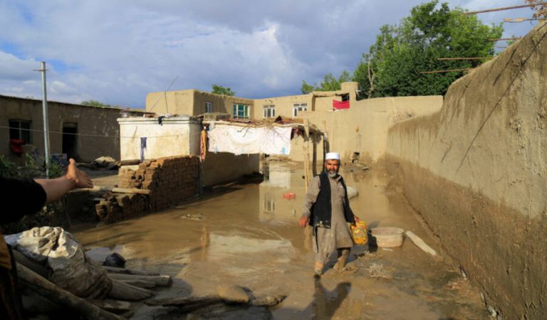 An Afghan man cleans up his damaged home after the heavy flood in the Khushi district of Logar, Afghanistan, August 21, 2022. REUTERS/Stringer
