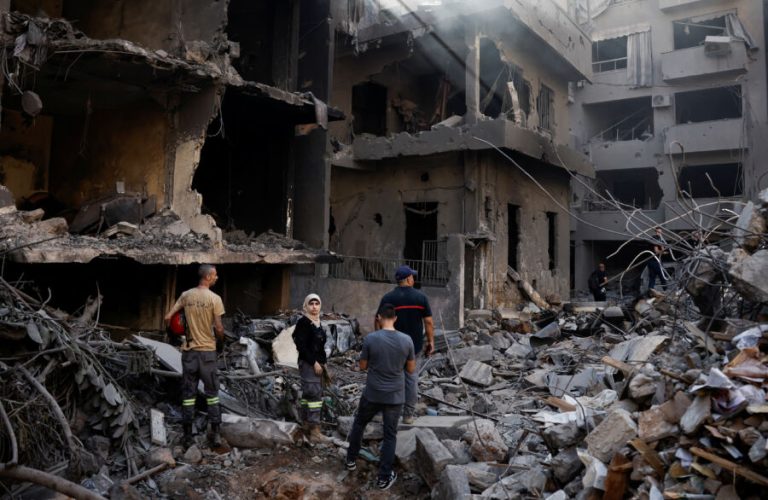 People inspect the site of an Israeli air strike, amid ongoing hostilities between Hezbollah and Israeli forces, in Beirut, Lebanon, October 11, 2024. REUTERS/Louisa Gouliamaki