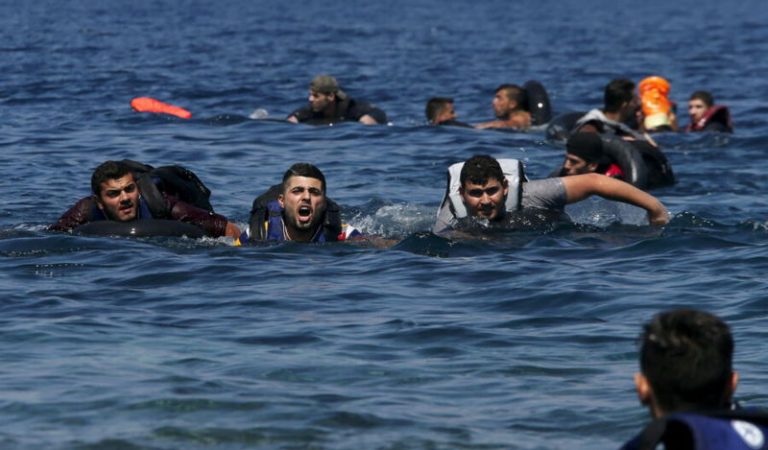 A refugee (2nd L) shouts as he swims towards the shore after a dinghy carrying Syrian and Afghan refugees deflated some 100m away before reaching the Greek island of Lesbos, September 13, 2015. Of the record total of 432,761 refugees and migrants making the perilous journey across the Mediterranean to Europe so far this year, an estimated 309,000 people had arrived by sea in Greece, the International Organization for Migration (IMO) said on Friday. About half of those crossing the Mediterranean are Syrians fleeing civil war, according to the United Nations refugee agency. REUTERS/Alkis Konstantinidis - RTSUQF