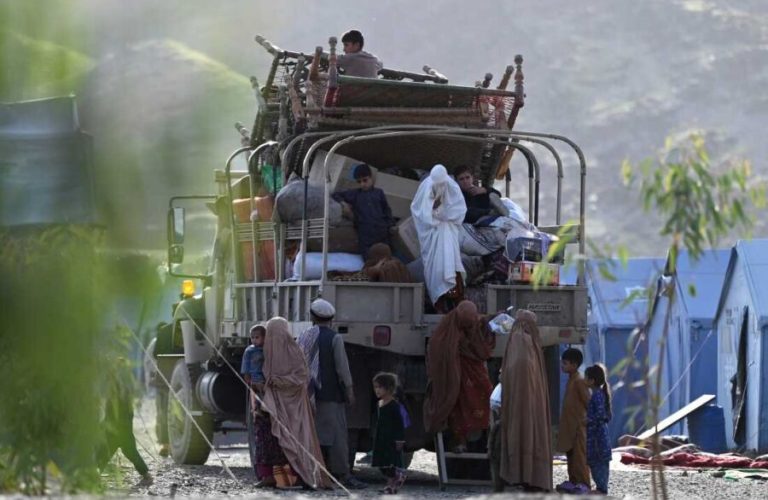 Afghan refugees climb down from a truck after arriving from Pakistan near the Afghanistan-Pakistan Torkham border in Nangarhar province on April 20, 2025. Pakistan has launched a strict campaign to evict by the end of the month more than 800,000 Afghans who have had their residence permits cancelled, including some who were born in Pakistan or lived there for decades. (Photo by Wakil KOHSAR / AFP) (Photo by WAKIL KOHSAR/AFP via Getty Images)