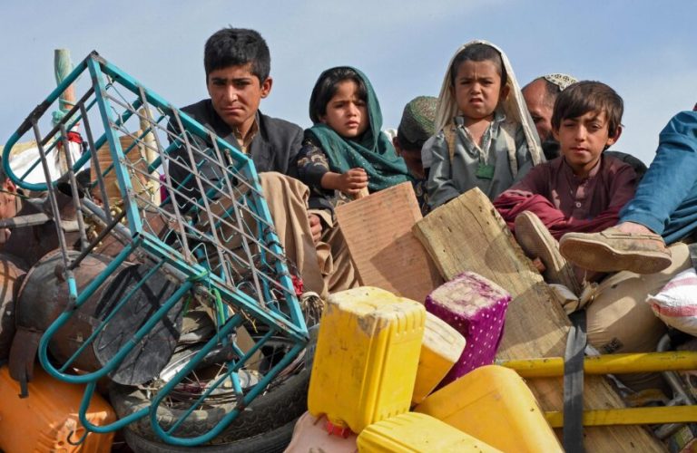 In this photo taken on November 4, 2023, Afghan refugee children along with their belongings arrive at the Chaman border to depart for Afghanistan. More than 180,000 people have returned to Afghanistan since Islamabad ordered 1.7 million Afghans it says are living illegally in Pakistan to leave or face deportation, border officials have said. (Photo by Banaras KHAN / AFP) (Photo by BANARAS KHAN/AFP via Getty Images)