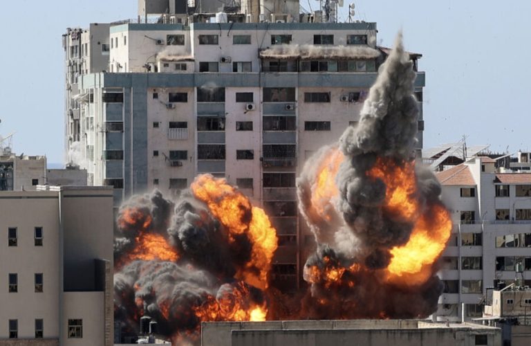 A ball of fire erupts from a building housing various international media, including The Associated Press, after an Israeli airstrike on Saturday, May 15, 2021 in Gaza City.   The attack came roughly an hour after the Israeli military ordered people to evacuate the building, which also housed Al-Jazeera and a number of offices and apartments. There was no immediate explanation for why the building was targeted.  (Mahmud Hams /Pool Photo via AP)