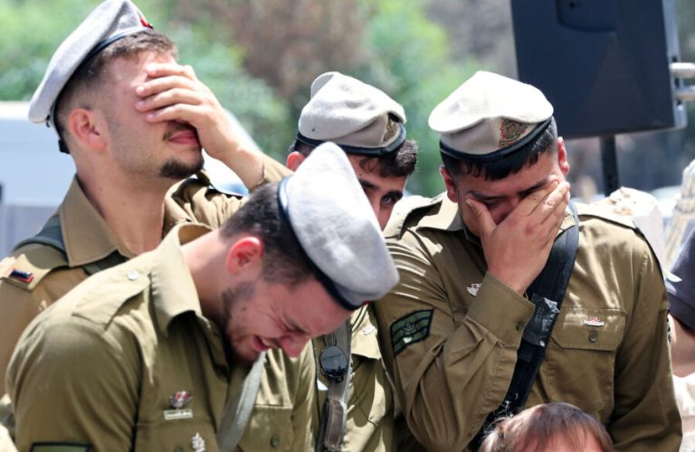 Israeli soldiers cry during the funeral of Matan Yashinovaki, 21, a soldier killed in the Gaza Strip, in Kfar Yona on June 26, 2025. Seven Israeli soldiers were killed in Gaza after an attack on their armoured vehicle on June 25, in one of the deadliest incidents for its forces in the more than 20-month war between Israel and Islamist militant group Hamas. (Photo by JACK GUEZ / AFP)