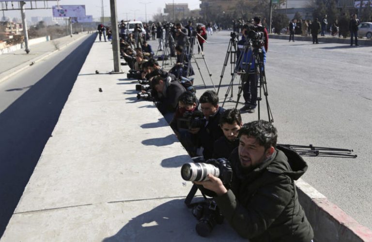 FILE- in this Sunday, Jan. 21, 2018, photo, Afghan journalists take photographs at the site of a deadly attack on the Intercontinental Hotel after an attack in Kabul, Afghanistan. Limiting access to information by the Afghan government is not acceptable, said an official form an Afghan watchdog after around 30 media outlets protested severe limitation to information in Afghanistan. (AP Photo/Rahmat Gul, file)