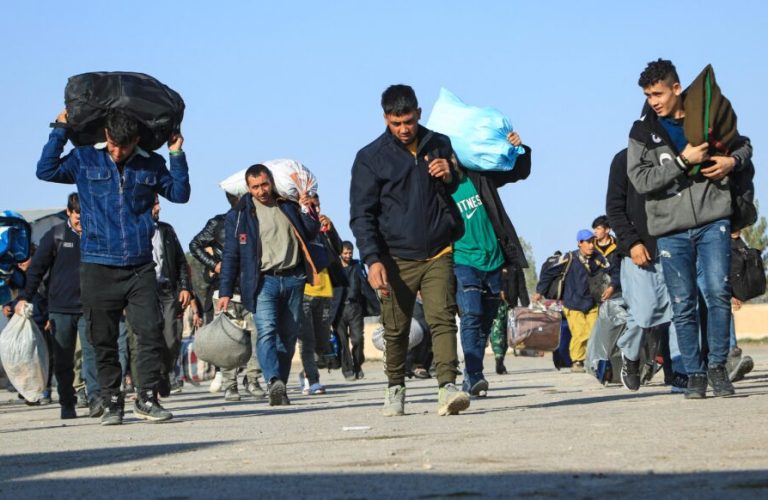 Afghan immigrants deporting back from Iran, carry their belongings at a registration centre in the Islam Qala border town of Herat province on November 6, 2023. (Photo by Mohsen KARIMI / AFP)