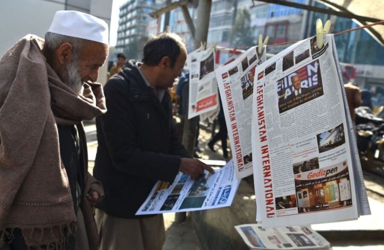 A man reads a local newspaper showing a photograph of newly elected US President Joe Biden, in Kabul on November 8, 2020. (Photo by WAKIL KOHSAR / AFP) (Photo by WAKIL KOHSAR/AFP via Getty Images)