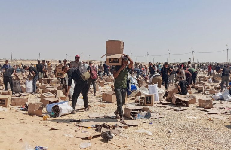 FILE PHOTO: Palestinians collect what remains of relief supplies from the distribution center of the U.S.-backed Gaza Humanitarian Foundation, in Rafah, in the southern Gaza Strip, June 5, 2025. REUTERS/Stringer/File Photo