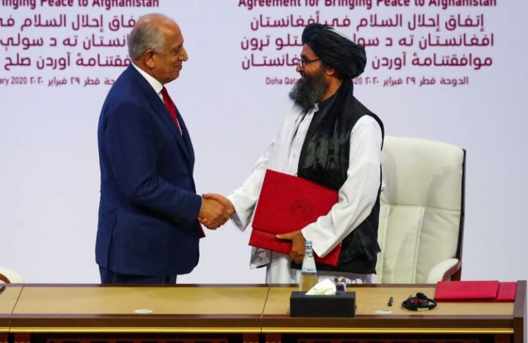 Mullah Abdul Ghani Baradar, the leader of the Taliban delegation, and Zalmay Khalilzad, U.S. envoy for peace in Afghanistan, shake hands after signing an agreement at a ceremony between members of Afghanistan's Taliban and the U.S. in Doha, Qatar February 29, 2020. REUTERS/Ibraheem al Omari
