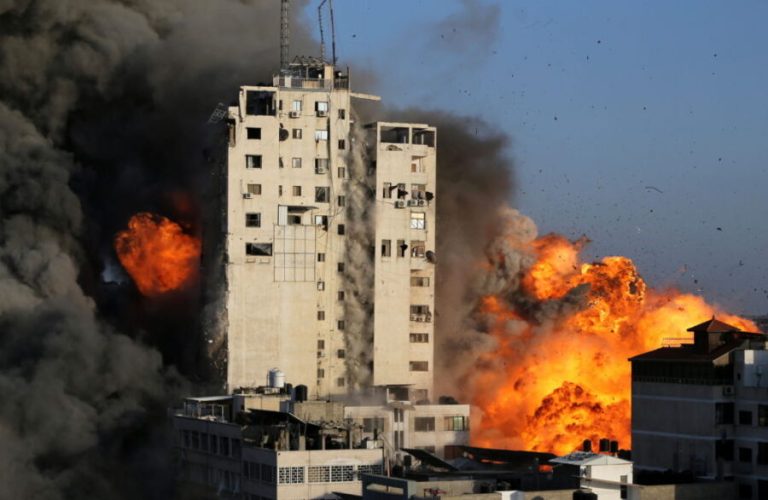 Smoke and flames rise from a tower building as it is destroyed by Israeli air strikes amid a flare-up of Israeli-Palestinian violence, in Gaza City May 12, 2021. REUTERS/Ibraheem Abu Mustafa