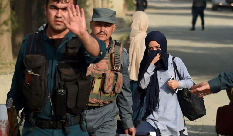 Afghan women students from the American University, who were trapped inside the premises during an attack by militants, are escorted by Afghan police forces at the end of a nearly 10-hour raid at the American University of Afghanistan in Kabul on August 25, 2016.At least nine people were killed after militants stormed the American University of Afghanistan in Kabul, officials said, in a nearly 10-hour raid that prompted anguished pleas for help from trapped students. / AFP PHOTO / WAKIL KOHSARWAKIL KOHSAR/AFP/Getty Images