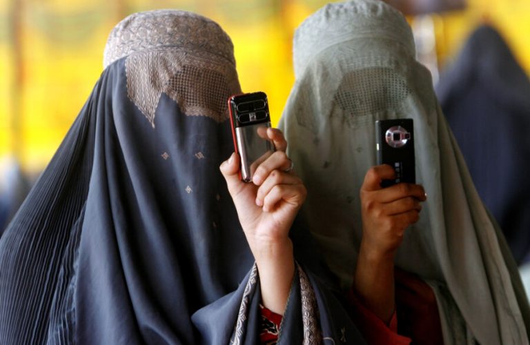 Afghan women take pictures during an election rally in support of their President Hamid Karzai in Kandahar province August 16, 2009. REUTERS/Stringer