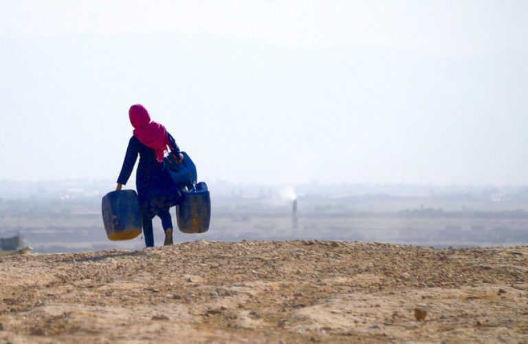 (FILES) This file photo taken on July 19, 2018 shows an Afghan girl (L) carrying empty containers to collect water, as a child looks on, in Sakhi village on the outskirts of Mazar-i-Sharif.
A 70 percent shortfall in snow and rain across most of Afghanistan in recent months decimated the winter harvest, threatening the already precarious livelihoods of millions of farmers and sparking warnings of severe food shortages, as Afghanistan's worst drought in decades ravages the war-torn country. / AFP PHOTO / FARSHAD USYAN / TO GO WITH Afghanistan-drought,FEATURE by Hamid Fahim and Emal Haidary
