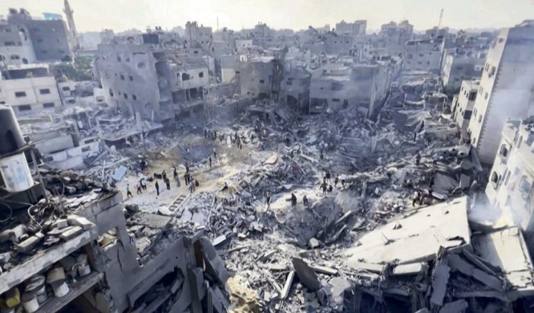 This image grab taken from AFPTV video footage shows Palestinians checking the destruction in the aftermath of an Israeli strike on the Jabalia refugee camp in the Gaza Strip, on November 1, 2023, amid ongoing battles between Israel and the Palestinian Hamas movement. Thousands of civilians, both Palestinians and Israelis, have died since October 7, 2023, after Palestinian Hamas militants based in the Gaza Strip entered southern Israel in an unprecedented attack triggering a war declared by Israel on Hamas with retaliatory bombings on Gaza. (Photo by AFP)
