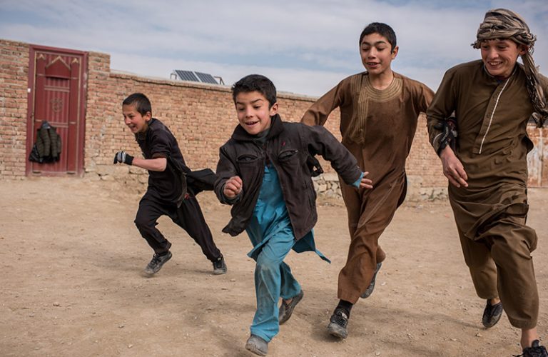Young boys play football in a village in Bagram, Afghanistan on December 16, 2017. This area was made safe for civilians through mine clearance operations.